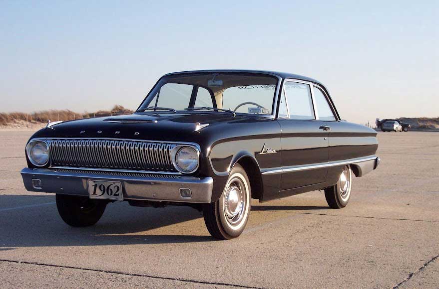 1962 black Ford car near beach